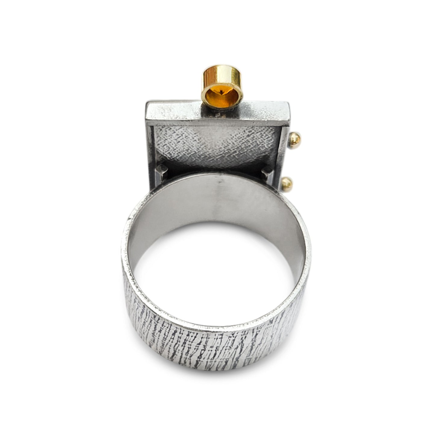 Silver ring with textured design and gold accents on a white background