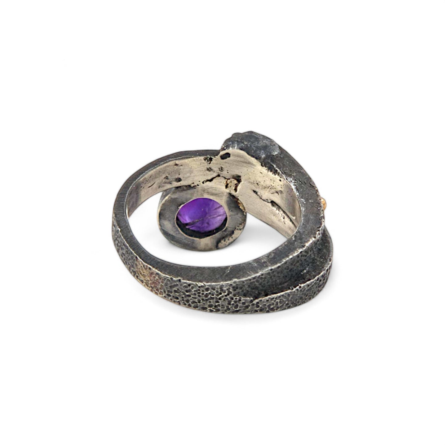 Silver ring with a purple gemstone on a white background
