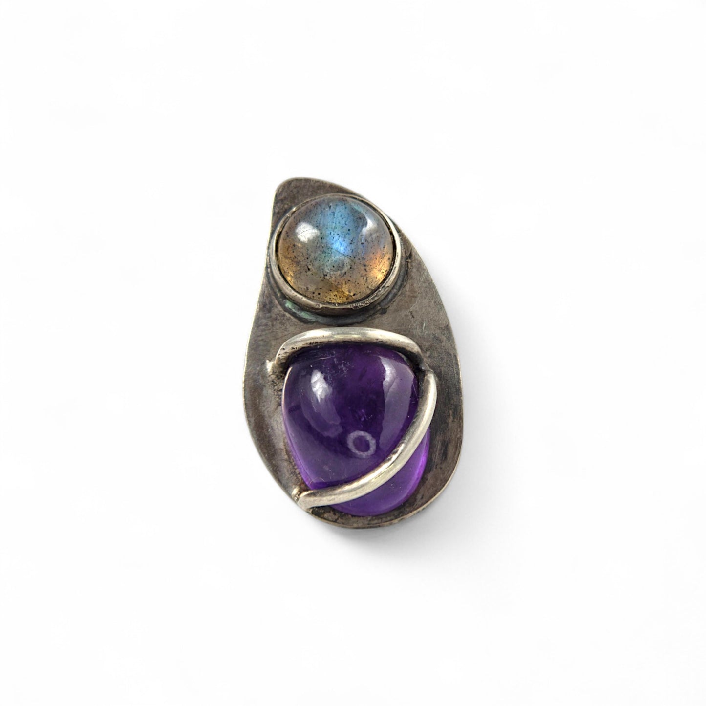 Jewelry ring with purple gemstone and labradorite on a white background