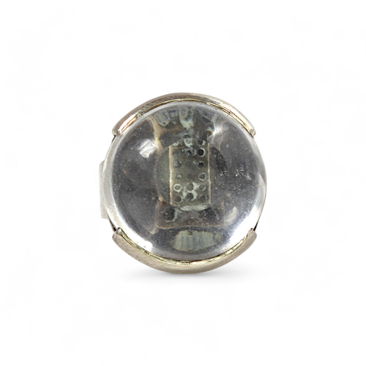 Round silver object with a clear center on a white background