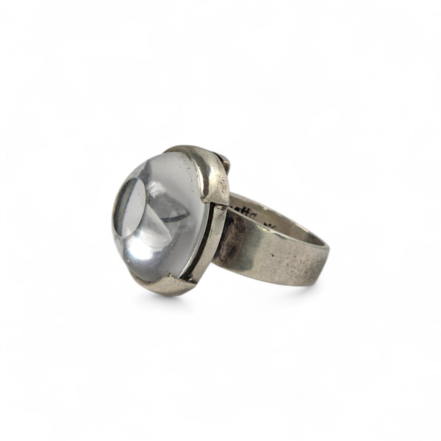 Silver ring with a large clear gemstone on a white background