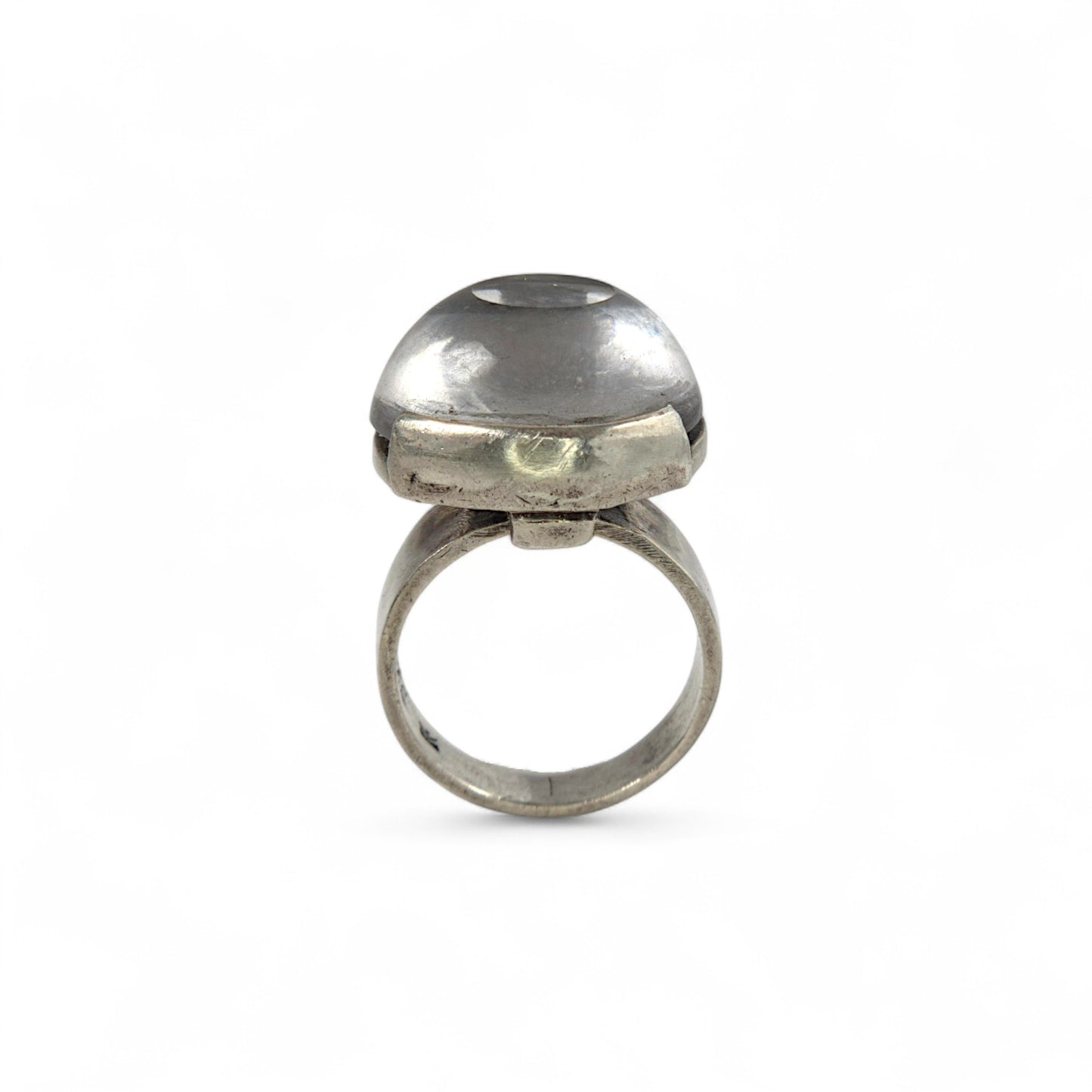 Silver ring with clear stone on a white background