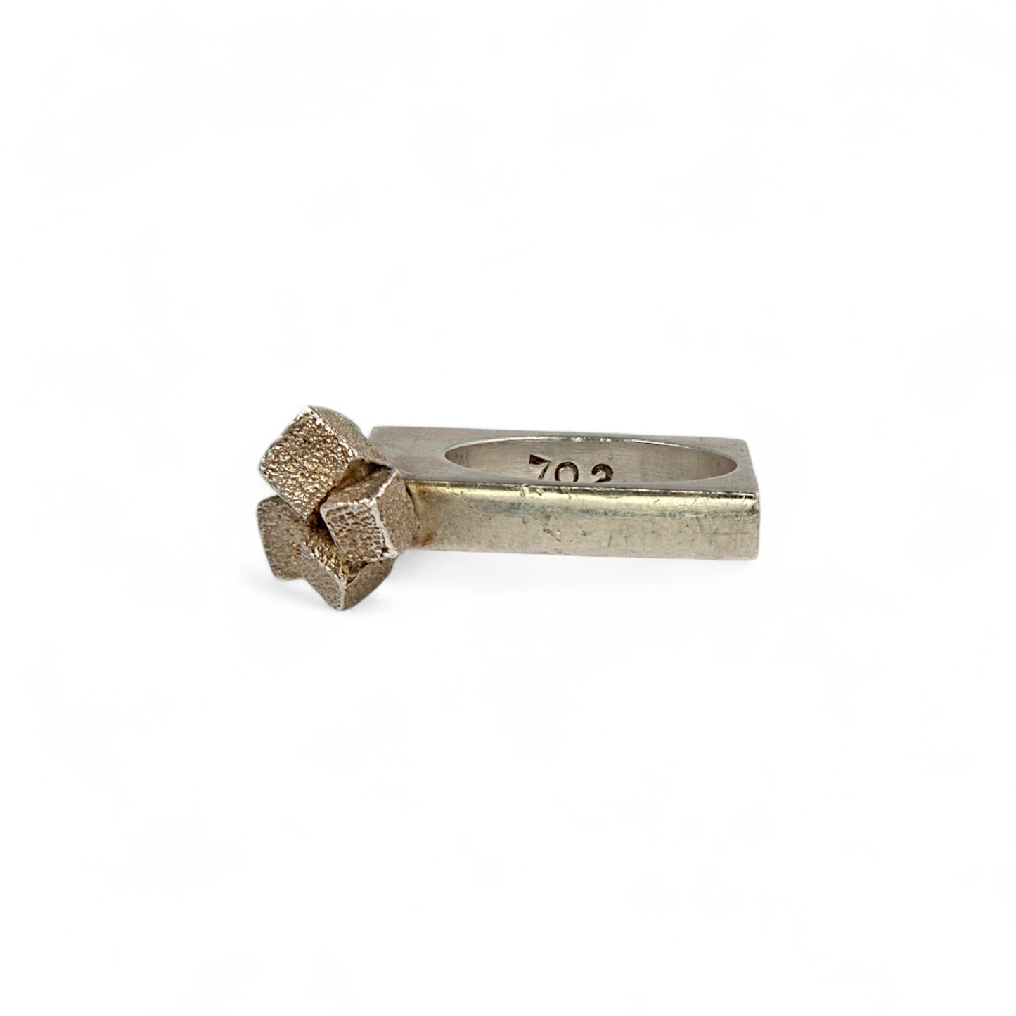 Silver ring with a cube design on a white background
