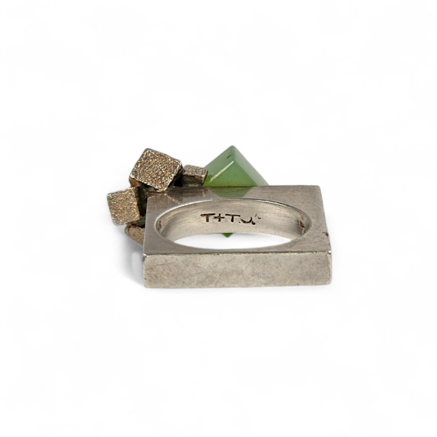 Silver ring with geometric stones on a white background