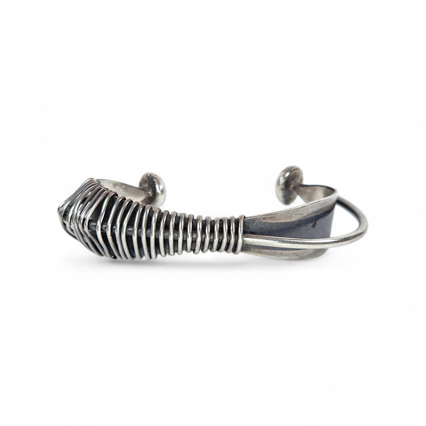 Silver wire-crafted bracelet on a white background