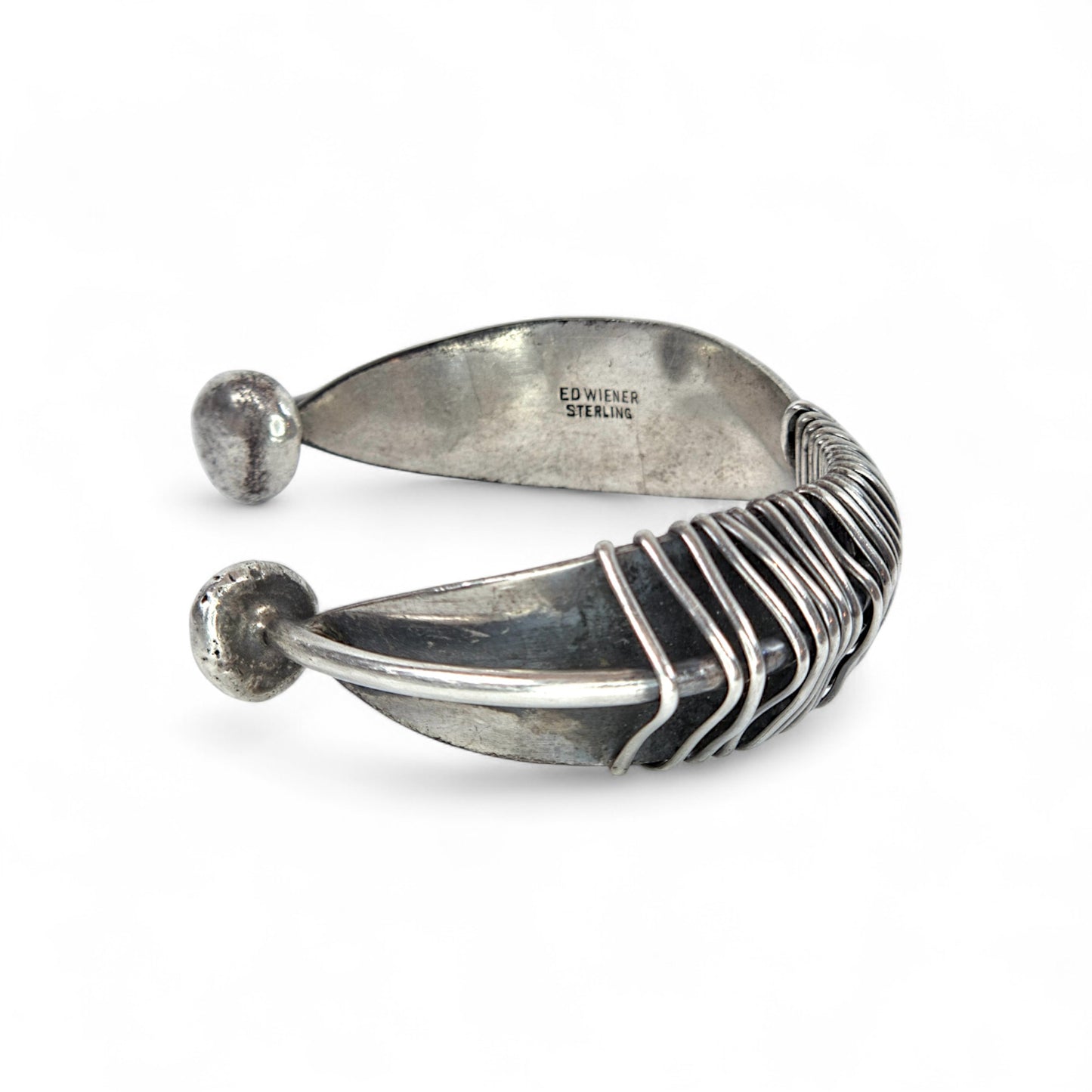 Silver feather-shaped bracelet on a white background