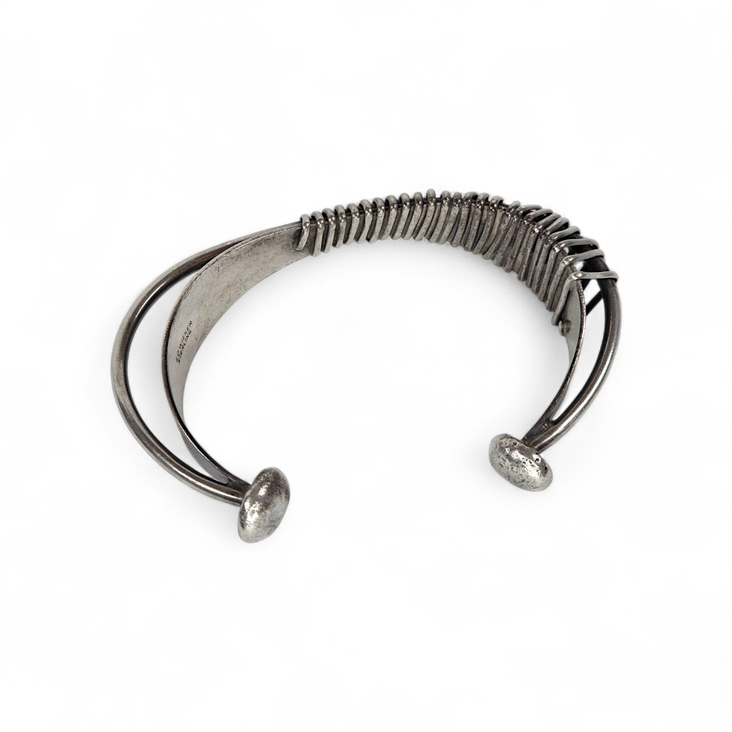 Silver bracelet with a unique design on a white background