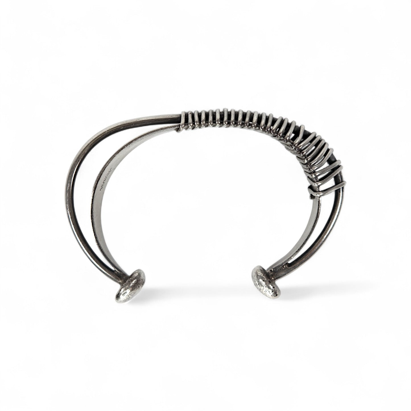 Silver bracelet with a textured band on a white background