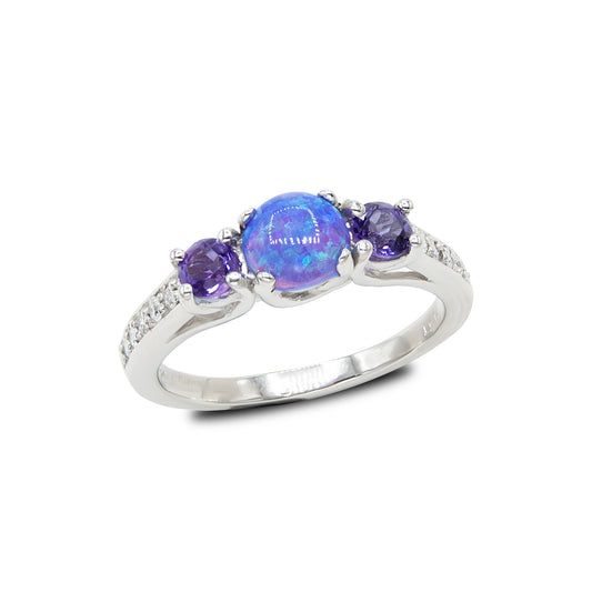 Platinum ring with a central blue opal stone flanked by two purple gemstones on a white background