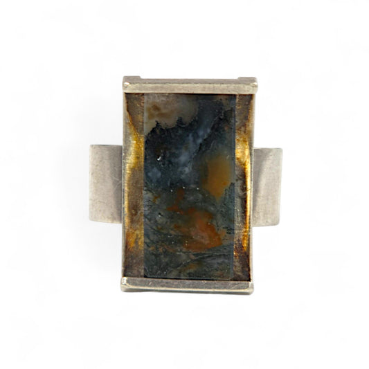 Rectangular stone ring with silver band on a white background