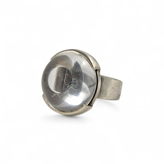 Silver ring with a spherical design on a white background