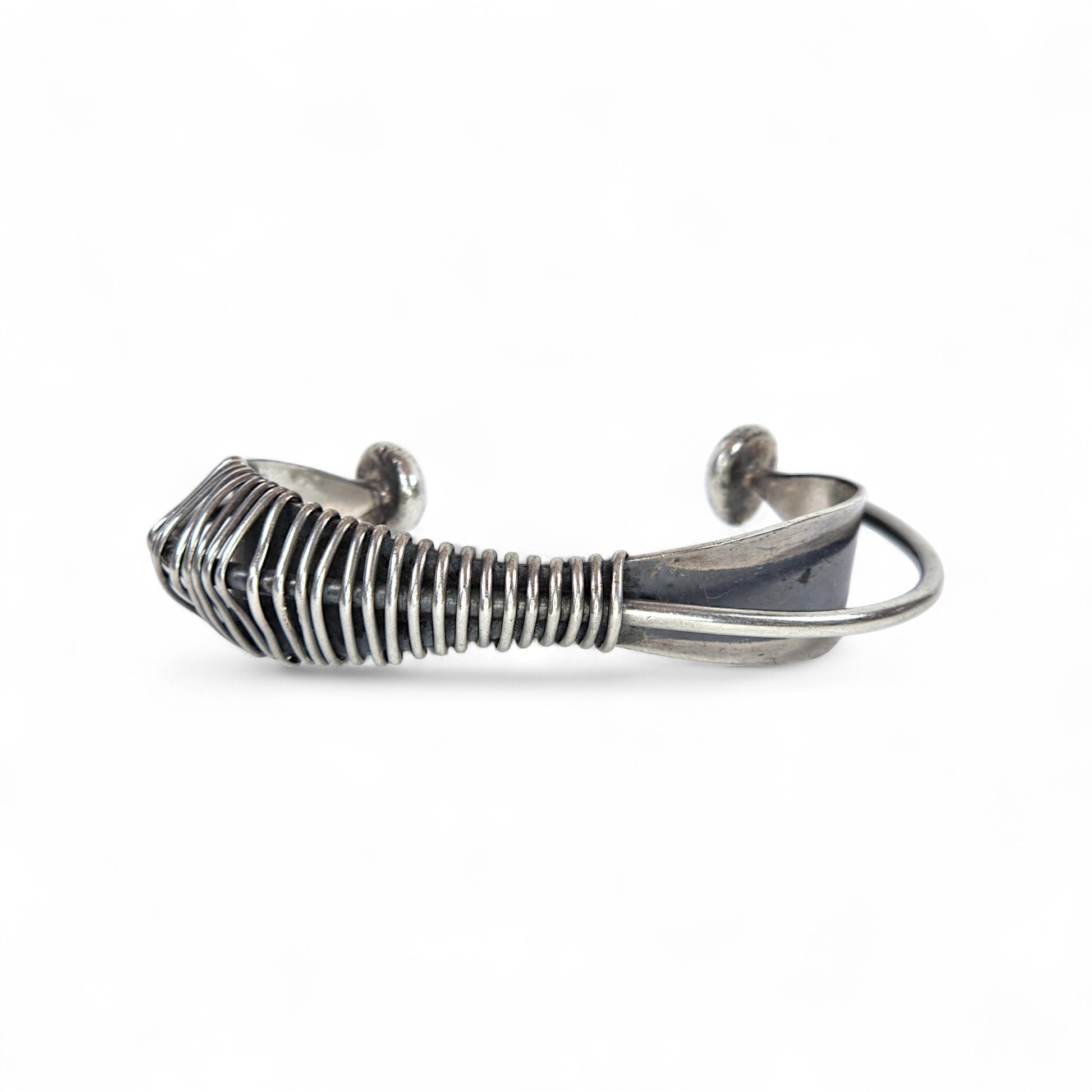 Silver wire-crafted bracelet on a white background