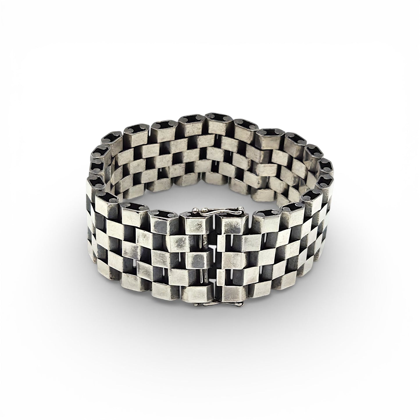 Silver bracelet with a checkered pattern on a white background