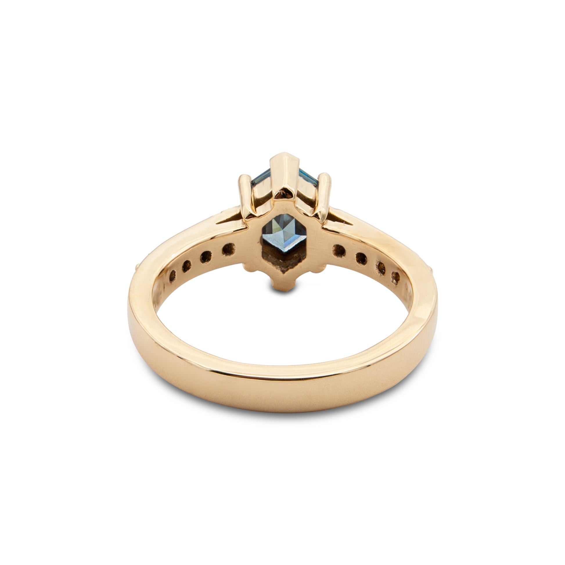 Gold ring with a central gemstone on a white background