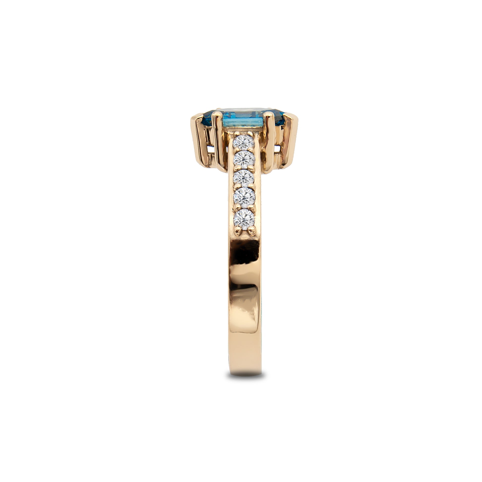Gold ring with a blue gemstone and smaller diamonds on a white background