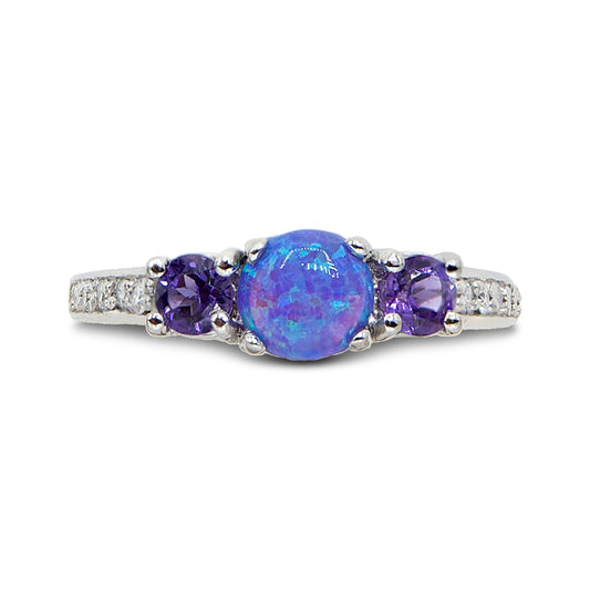 Ring with a blue opal and purple gemstones on a white background