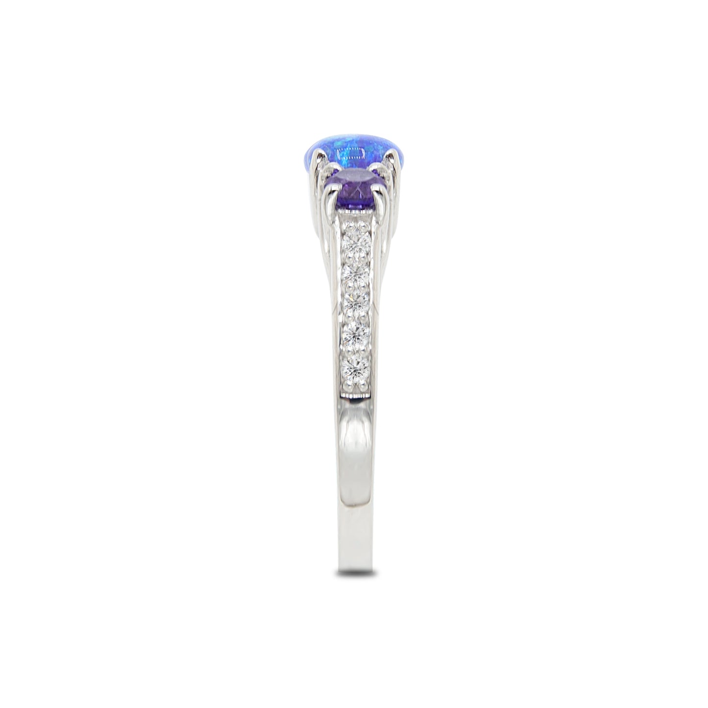 Platinum ring with a blue gemstone and small diamonds on a white background