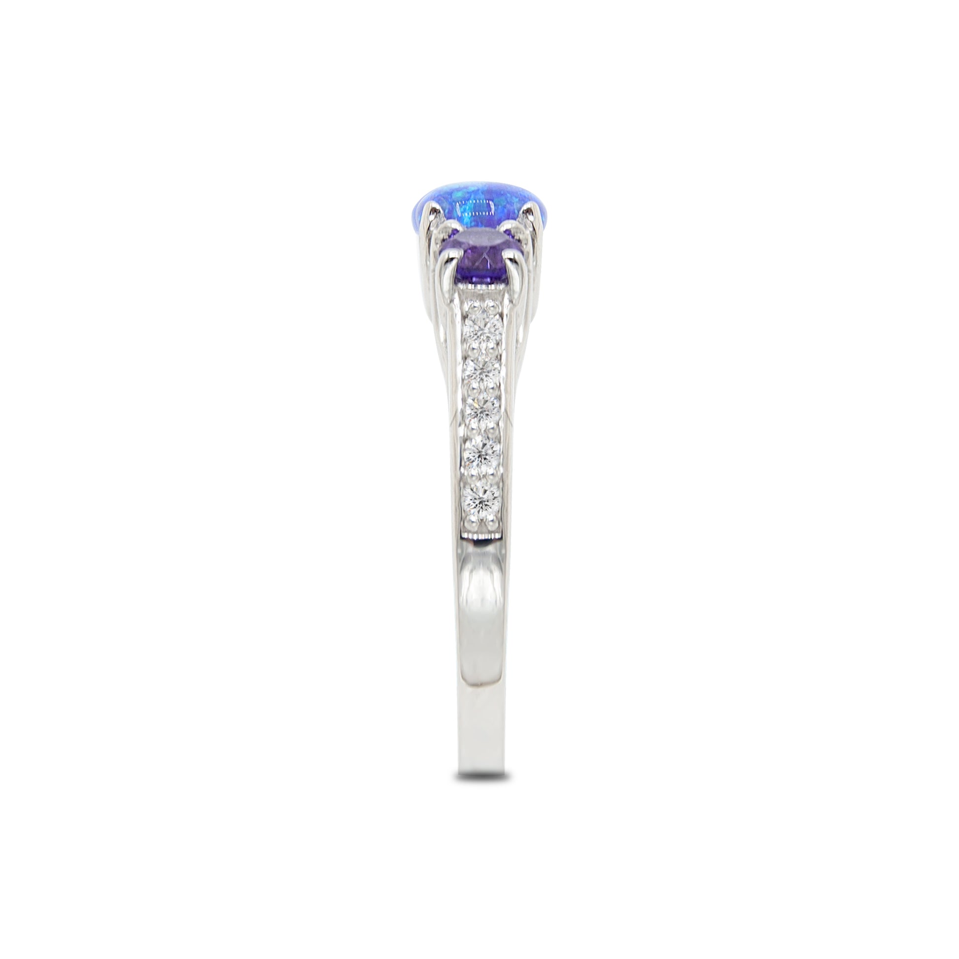 Platinum ring with a blue gemstone and small diamonds on a white background