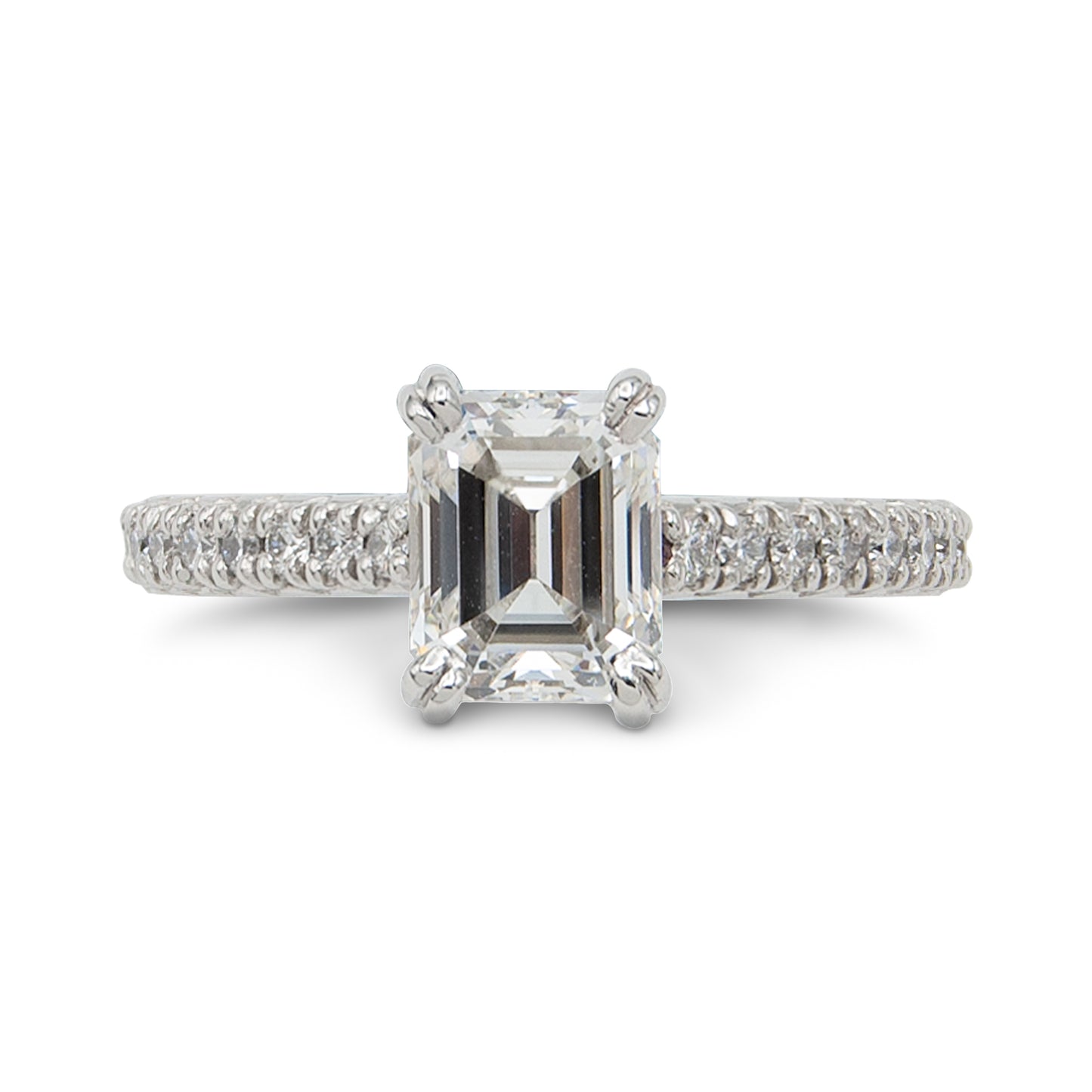 Diamond ring with a rectangular center stone on a white background