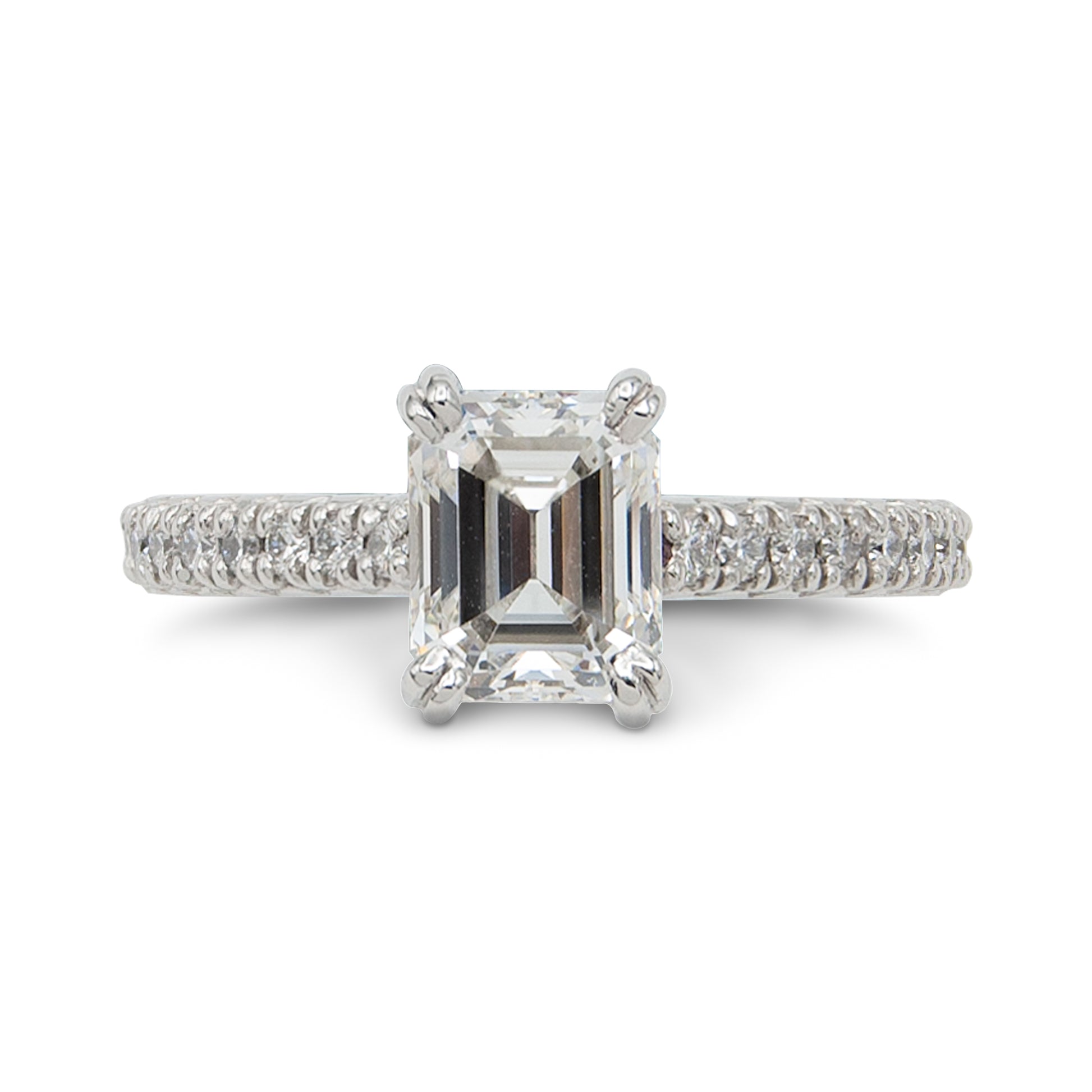 Diamond ring with a rectangular center stone on a white background